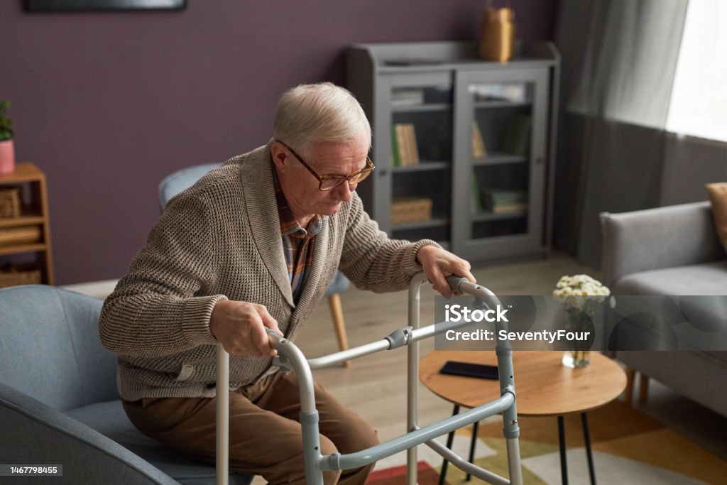 Senior woman relaxing in a lift chair while using a tablet